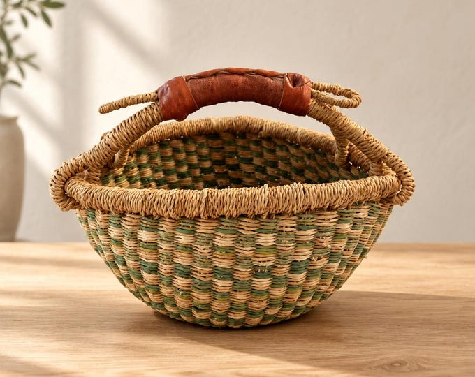 Vintage hand-woven Ghanaian Bolga basket with leather handle. 8” x 9.5”