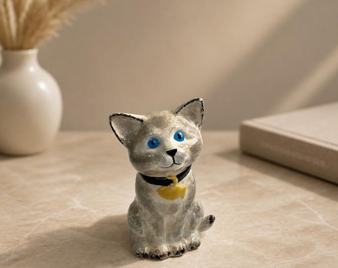 Vintage ceramic cat bank with blue eyes and fish pendant 6.5” x 3.5”