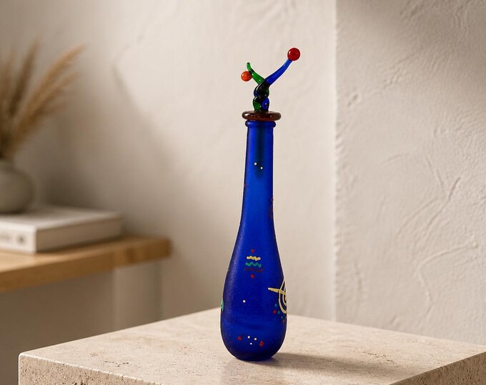 Vintage hand blown, hand painted art glass bottle with whimsical stopper. 9” tall