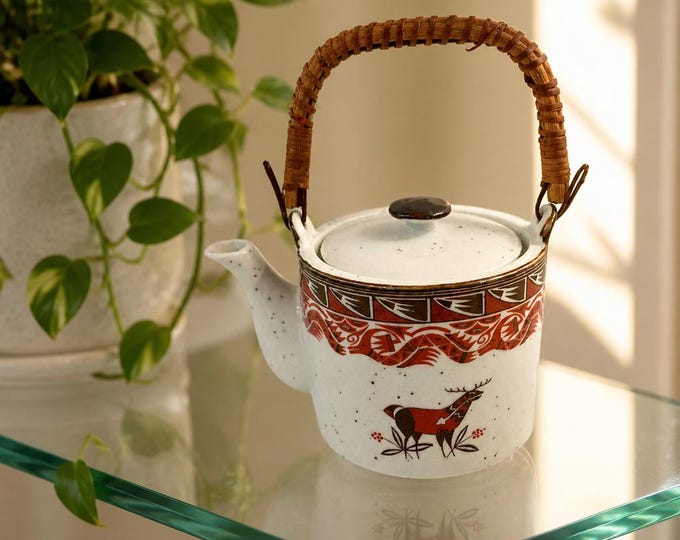 Vintage speckled ceramic teapot with deer pattern