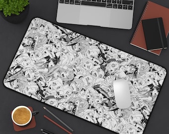 May include: Black and white rectangular desk mat featuring a repeating anime-style illustration. The mat has a black border and is shown with a laptop, mouse, and other desk accessories.
