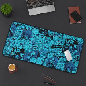 Può includere: Un tappetino per mouse rettangolare blu e nero con un'illustrazione ripetuta in stile anime. Il design include vari volti con la bocca aperta e la parola "WHA" in fumetti. Un mouse per computer bianco è appoggiato sul tappetino.