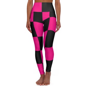 May include: High-waisted leggings with a bold checkerboard pattern in black and hot pink. The leggings are form-fitting and made of a stretchy material, perfect for workouts or casual wear.