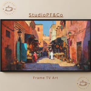 May include: A framed digital art print showing a vibrant marketplace scene with orange and pink buildings. The artwork features people in traditional dress, market stalls, and the text "Studio PF&Co" and "Frame TV Art".
