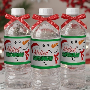 May include: Three clear water bottles with white caps, each adorned with a red polka-dot bow. The labels feature a smiling snowman face with a carrot nose, a red scarf, and the text "Melted Snowman".