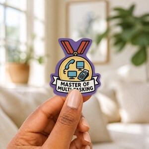 May include: A die-cut sticker shaped like a gold medal with a purple border and a red ribbon. The center features icons of a telephone, two computer monitors, and a calculator. A white banner at the bottom displays the text MASTER OF MULTITASKING.