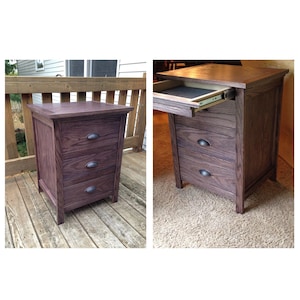 May include: A wooden, three-drawer cabinet with a dark stain. The cabinet has a rectangular shape with a flat top and curved drawer pulls. One image shows the top drawer open, revealing a black interior.