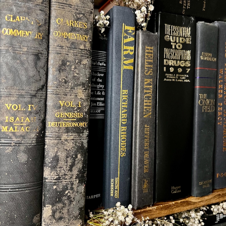 May include: A selection of vintage books with worn, textured covers. Titles include "Farm" by Richard Rhodes, "Hells Kitchen" by Jeffery Deaver, and "The Essential Guide to Prescription Drugs 1997". The books are displayed on a wooden shelf.