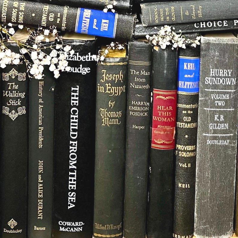 May include: A selection of vintage books, including titles such as "The Child From The Sea" and "Hurry Sundown." The books are mostly black with gold lettering and some have floral decorations. The spines show authors and publishers.