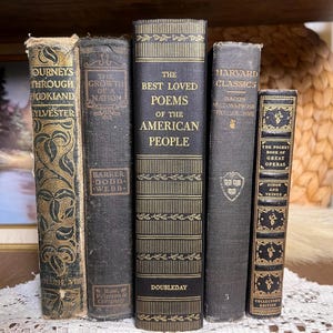 May include: A selection of vintage books with dark covers and gold lettering. Titles include "Journeys Through Bookland," "The Growth of a Nation," and "The Best Loved Poems of the American People." The books are displayed upright.
