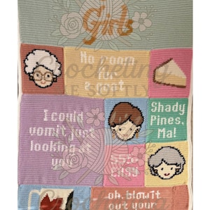 May include: A crocheted blanket with panels featuring quotes and images from "The Golden Girls." The blanket has a light green background with the words "The Golden Girls" at the top. Panels include character portraits and phrases, all hand-stitched.