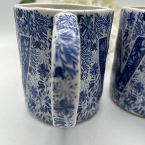 Monogram pieśni ludowej Anthropologie w kształcie litery „W” na obu kubkach. Niebiesko-biały wzór kwiatowy. zdjęcie 5