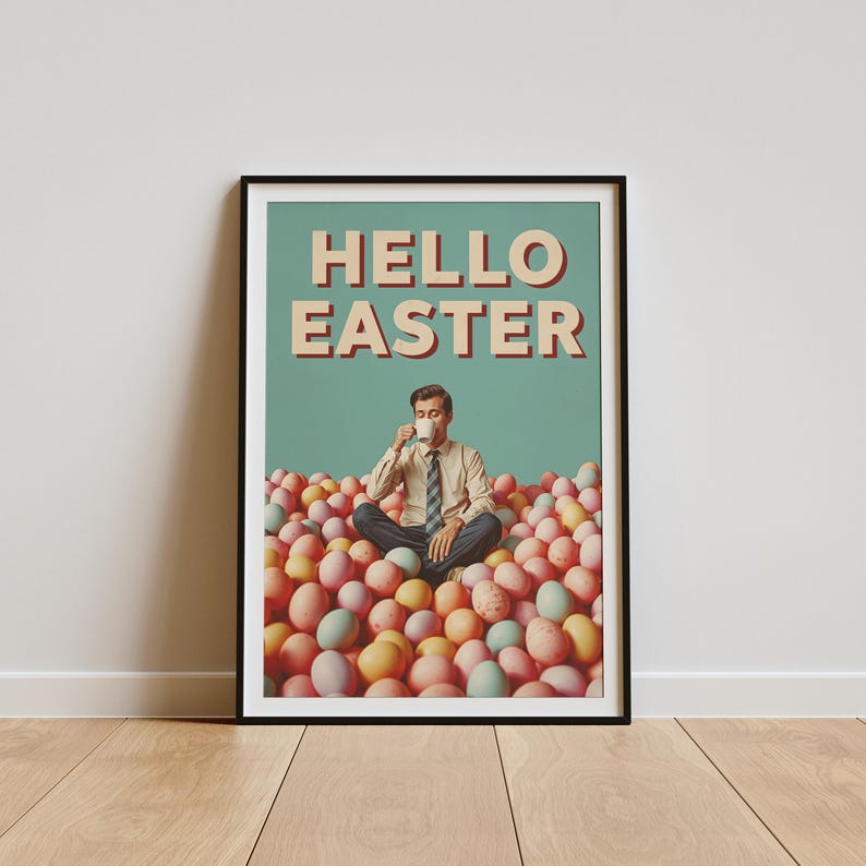 May include: A framed poster with the words "HELLO EASTER". The image shows a person sitting cross-legged in a pile of pastel-coloured Easter eggs, drinking from a white mug. The poster has a retro style.