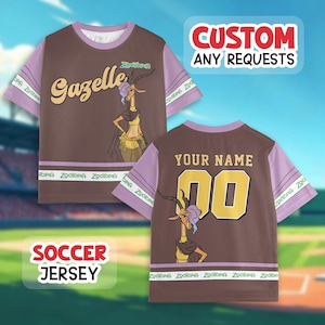 May include: Brown soccer jersey with purple sleeves featuring a cartoon gazelle character. The front says "Gazelle" and the back has "YOUR NAME" and the number "00". The jersey has the text "CUSTOM ANY REQUESTS" and "SOCCER JERSEY".