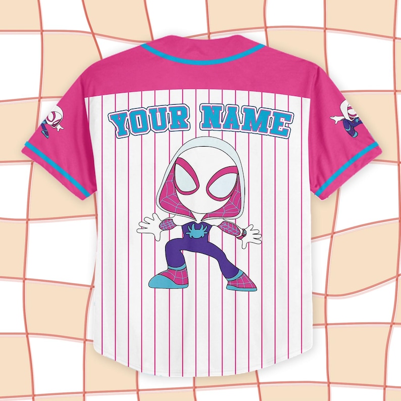 May include: White baseball jersey with pink and blue accents. Features a cartoon Spider-Gwen character on the back, with the text "YOUR NAME" above the character. The jersey has vertical pink stripes.