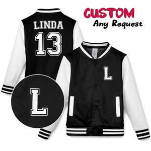 May include: Black and white letterman jacket with the name "LINDA" and the number "13" on the back. The front of the jacket has the letter "L". The sleeves are white, and the body is black. The text "CUSTOM Any Request" is in the upper right corner.