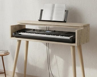 May include: A black digital piano with white keys is set into a light wood-toned stand. A music stand holds sheet music above the keyboard. The stand has angled legs and a shelf for the keyboard.