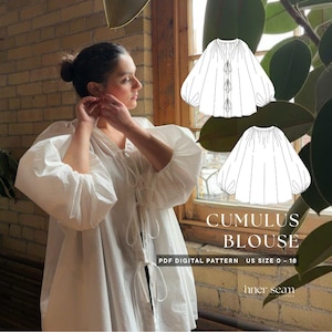 May include: A white blouse with voluminous sleeves and a tie-front closure. The image also includes a line drawing of the blouse and the text "CUMULUS BLOUSE" and "PDF DIGITAL PATTERN US SIZE 0 - 18". The blouse is made of a lightweight fabric.
