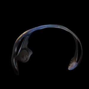 May include: Black and blue sports headphones with a curved design. The headphones have a sleek, modern aesthetic, with a focus on ergonomic design for comfort during workouts or other activities. The ear pieces are visible.