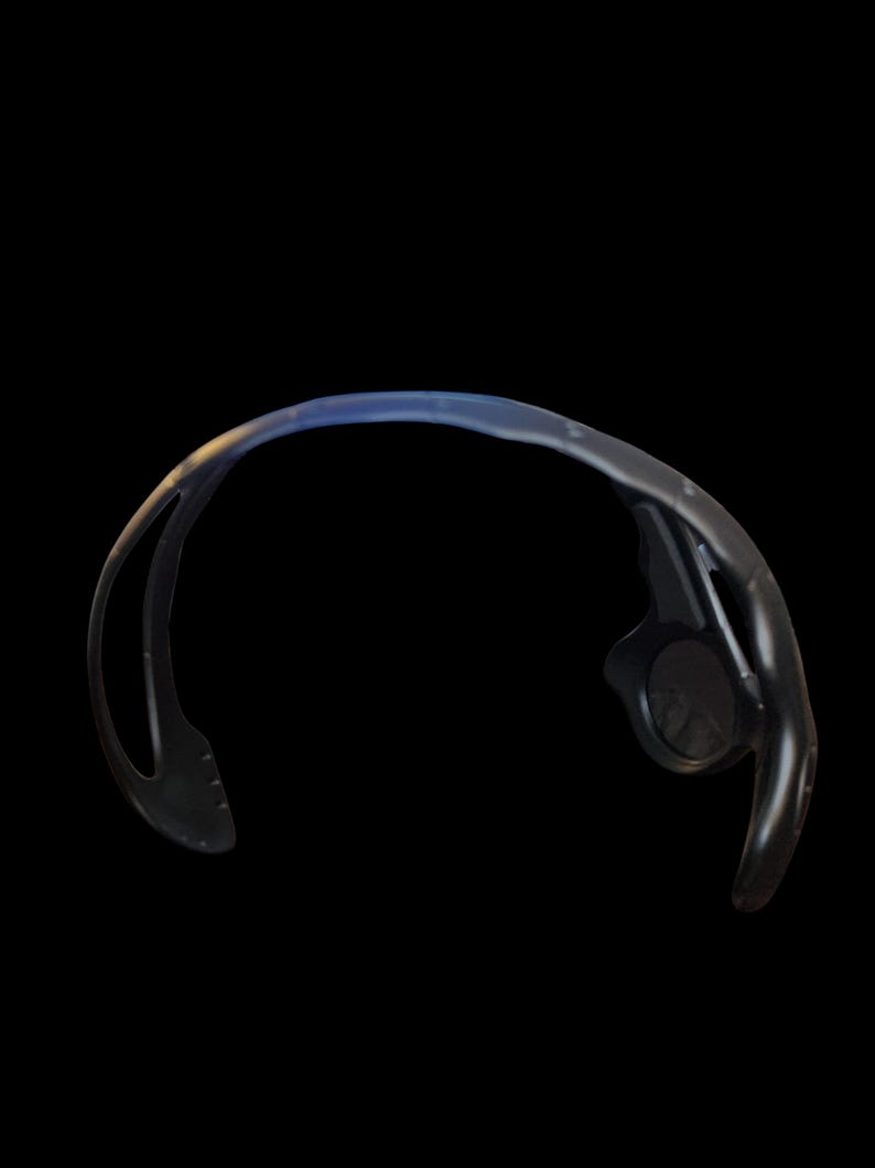 May include: Black sports sunglasses with a curved frame and a dark lens. The sunglasses have a sleek, modern design, suitable for outdoor activities. The frame appears to be made of a durable material.