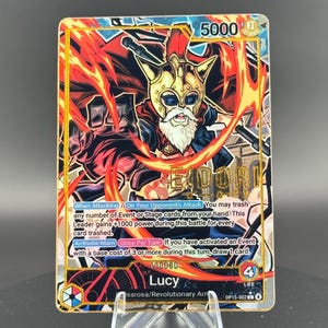 May include: A gold foil trading card featuring a character with a helmet and a white beard, surrounded by flames. The card has the text "Gold Foil Signature" at the top and includes game-related text and the name "Lucy".
