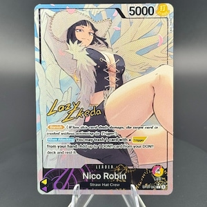 May include: A One Piece trading card featuring Nico Robin as a leader. The card displays a character illustration with a white hat, black top, and text including Banish, When Attacking, and the signature Lazy Ikeda. It has a power of 5000 and 4 life.