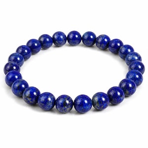 May include: A circular stretch bracelet composed of smooth, round, deep blue lapis lazuli beads. Each bead features natural variations in color, including subtle flecks of gold pyrite and darker blue inclusions, arranged in a continuous loop.