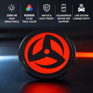 May include: A circular electronic display featuring a red and black three-pronged shuriken-style graphic. Text icons above indicate 1000 nit high brightness, RGB888 24-bit true color, water and dust proof, iOS and Android app support, and car system connectivity.
