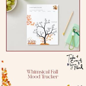 May include: A white "Comfy Mood Tracker" sheet with a tree design, autumn leaves, and pumpkins. The text "Whimsical Fall Mood Tracker" is at the bottom. A pencil, keys, and a bowl of grapes are also visible.