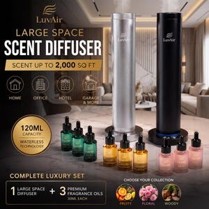 Puede incluir: Dos difusores de aroma cilíndricos altos en plata y negro, con la marca LuvAir. El set incluye tres frascos de aceite aromático de 30 ml en tonos verde, ámbar y rosa. El texto indica una capacidad de 120 ml y tecnología sin agua.