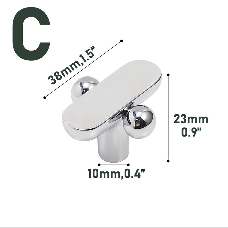 May include: A chrome-finished cabinet knob with a rounded rectangular top and two spherical accents. The knob measures 1.5 inches long, 0.9 inches high, and 0.4 inches wide. The letter "C" is in the upper left corner.