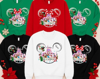 May include: A collection of Christmas sweatshirts in various colors, including green, red, black, and white. Each sweatshirt features a Disney-themed design with a castle, characters, and the word "Christmas". Some sweatshirts have names like "Jennie", "Mommy", "Daddy", "Jack", and "Emily".