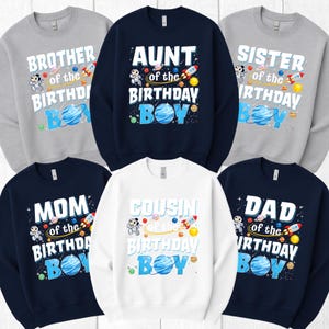 May include: A collection of crewneck sweatshirts in various colors, each with a unique design for a birthday celebration. The sweatshirts feature phrases like "Brother," "Aunt," "Sister," "Mom," "Cousin," and "Dad" with "of the Birthday Boy" text, along with space-themed graphics.