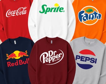May include: A selection of crewneck sweatshirts in different colours, each displaying a logo of a popular beverage brand. The sweatshirts include Coca-Cola in red, Sprite in white, Fanta in orange, Red Bull in navy, Dr. Pepper in burgundy, and Pepsi in grey.