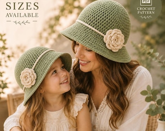 May include: Two sage green crochet bucket hats with a cream-colored band and a matching cream crochet flower accent on the side. The image includes text stating 3 SIZES AVAILABLE and PDF CROCHET PATTERN, indicating this is a digital pattern.