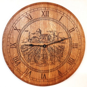 May include: A wooden clock with Roman numeral markings and a design of a vineyard and a small village. The clock face is brown with a black rope design around the edge.