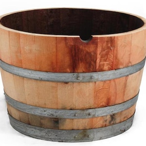 May include: A wooden barrel planter with metal hoops. The planter is made of natural wood and has a rustic look. It is perfect for planting flowers or herbs.