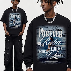 May include: Black t-shirts and a long-sleeve shirt with a graphic design. The design features the text "I'M LOVING FOREVER Rin YOU'RE like Quidin" over a blue ocean scene. The model is wearing black cargo pants and a silver chain.