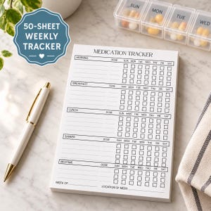 May include: A white paper medication tracker notepad with black text and grid lines for morning, breakfast, lunch, dinner, and bedtime doses across seven days of the week. The notepad includes a space for the week and location of meds.