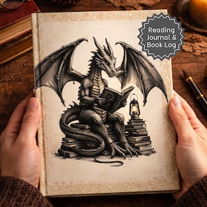 May include: A hardback book titled Reading Journal & Book Log featuring a black and white illustration of a winged dragon sitting on a stack of books while reading, accompanied by a small lantern, set against a light beige patterned background.