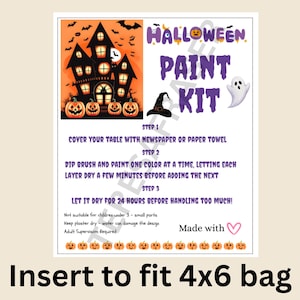 May include: A rectangular Halloween paint kit instruction card featuring a haunted house illustration, pumpkins, a ghost, and a witch hat. The text includes step-by-step painting instructions, safety warnings, and the phrase Made with a heart icon.