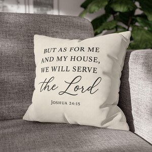 May include: Cream-coloured square cushion with the text "BUT AS FOR ME AND MY HOUSE, WE WILL SERVE the Lord JOSHUA 24:15" in black script. The cushion is on a grey sofa.