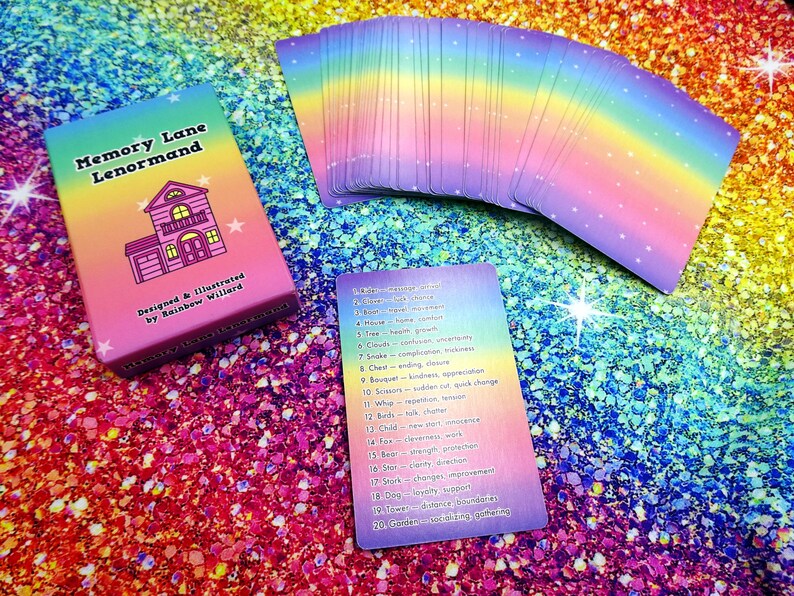 May include: A deck of "Memory Lane Lenormand" cards with a rainbow gradient design. The box features a house illustration and text. A spread of cards and a single card with numbered keywords are also visible, all on a glittery, rainbow-colored surface.