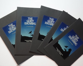 May include: Five identical black booklets arranged in a fan shape. Each cover features a rectangular label with a blue gradient sky, a silhouette of a person reaching toward a bird, and the text THE QUIET KNOWING, 1-Card Reading, and Rainbow Willard.