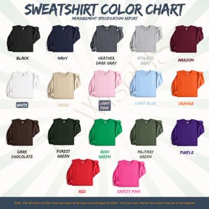 May include: A sweatshirt color chart displaying various colors, including black, navy, heather dark gray, athletic gray, maroon, white, sand, light pink, light blue, orange, dark chocolate, forest green, Irish green, military green, purple, red, and safety pink.