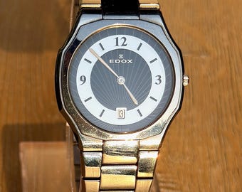 Reloj Edox Les Agaces de cuarzo vintage / Esfera bicolor negra con efecto rayos de sol, caja octogonal, fabricado en Suiza, fecha, cristal de zafiro, brazalete original.