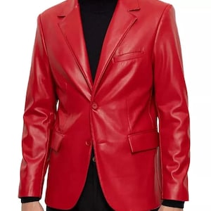 May include: A vibrant red blazer featuring a smooth finish, a notched lapel, long sleeves, and two front flap pockets. The jacket is designed with a single-button closure at the centre and a single welt pocket on the upper left chest area.