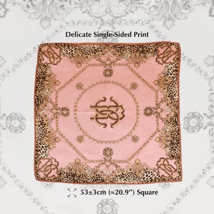 May include: A square pink scarf with a delicate single-sided print. The scarf features a gold and brown ornate design with a leopard print border. The scarf measures approximately 20.9 inches square.