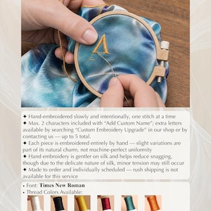 May include: A close-up of a hand embroidering a letter "A" onto a blue and teal fabric using a wooden embroidery hoop. The text "Additional Custom Embroidery Service" is at the top. Thread colors available are white, black, gold, red, aqua blue, and orange.