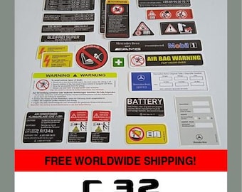 May include: A collection of various Mercedes-Benz stickers, including warning labels, service information, and model-specific decals. The stickers feature text and graphics in multiple colors, with the text "C 32" and "Set of stickers Mercedes-Benz" at the bottom.